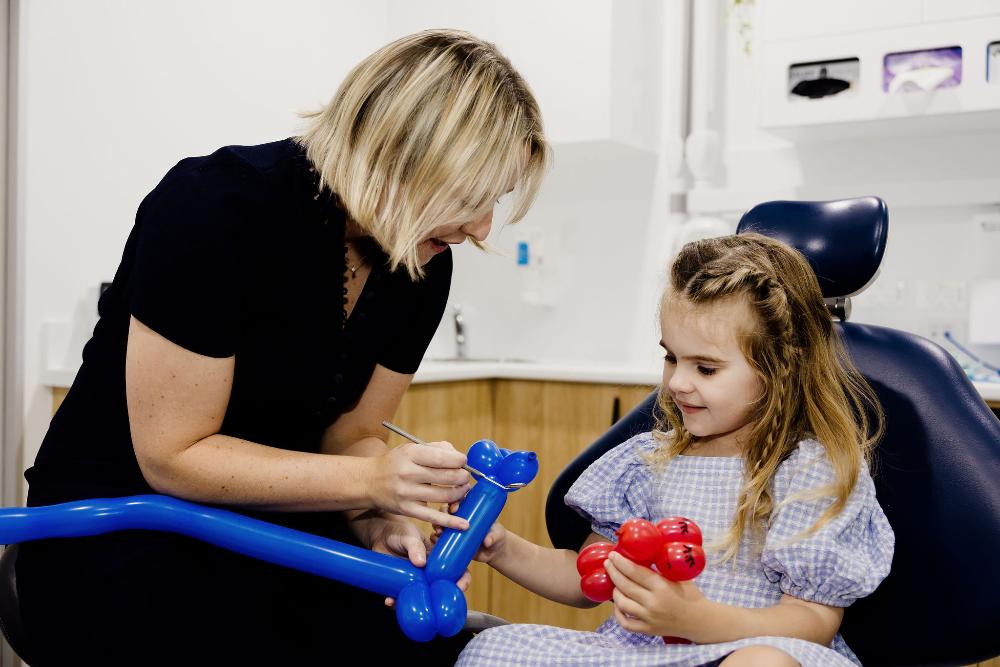 A woman and a little girl comfortably seated in a dentist chair at northside dental solutions in Clayfield