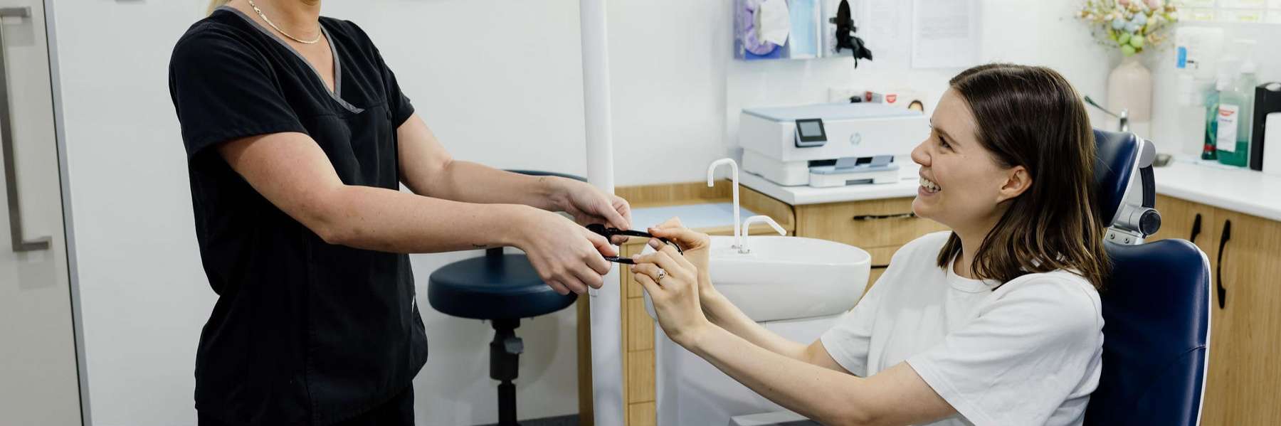 Smiling patient receiving cosmetic dentistry consultation in a dental clinic in Clayfield