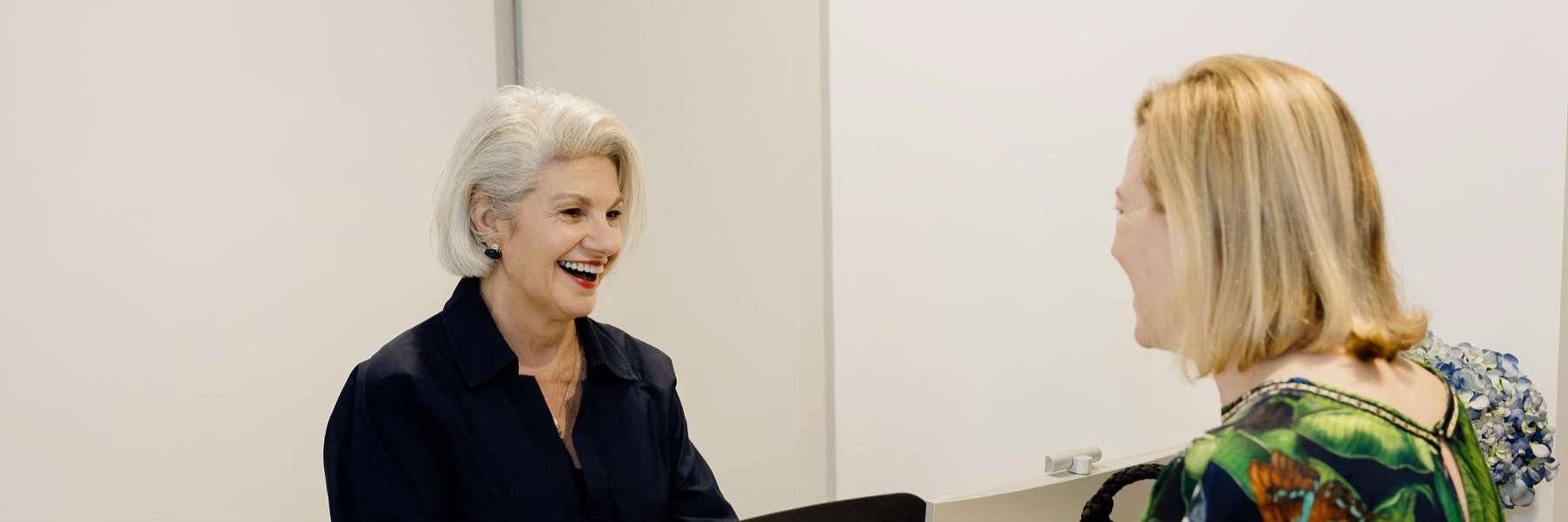 Two women talking in an office, focused on Full Mouth Reconstruction services at Northside Dental Solutions Clayfield.